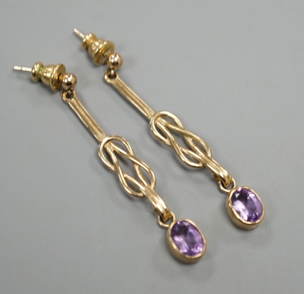 A modern pair of 9ct gold and amethyst set drop earrings, 4cm, gross 3.8 grams.